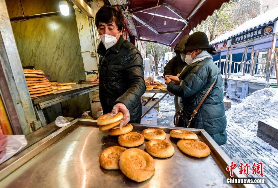 烏魯木齊市文化路，已開門營業(yè)的馕店吸引過往市民前來購買。 劉新 攝